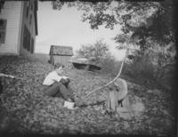 Porter Thayer next to grindstone at Abbie Adams residence, Williamsville, Vt.