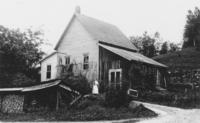 Woman with cat, standing in front of the Wardsboro, Vt Creamery