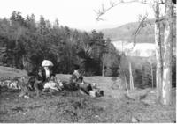 Asylum Meadow, two women having a picnic on a hillside with a dog