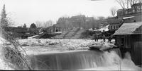 Dam with piles of logs in the background