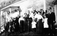 Family portrait, standing in front of house