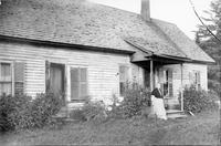 Woman leaning against the front porch