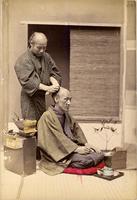 An elderly man getting his hair styled