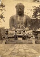 Monks in front of a large statue of Buddha