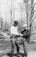 Workers rolling up tubing