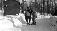 Two workers in front of the research shed