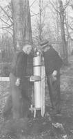 E. Root and Dean Carrigan checking collection tank